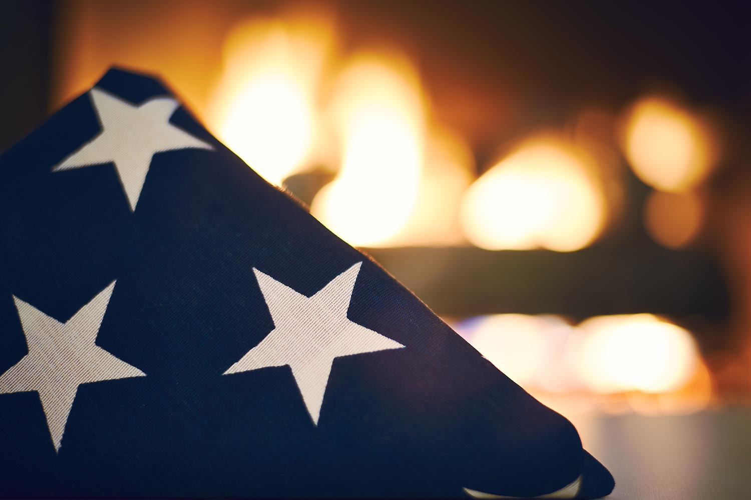 Folded American flag by the fire